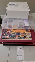 Overall lot with binders stacked, stamp album book, and two plastic containers visible