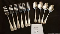 Six Birks Regency Plate dinner forks and four soup spoons arranged on dark cloth, showing shape and condition of flatware.