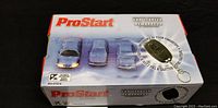 White and red ProStart branded box for a remote control car starter with images of cars and the remote starter key fob.