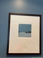 Framed painting hanging on wall showing surroundings and frame details.