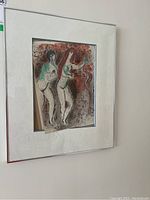 Framed Marc Chagall print mounted on wall, showing the whole framed piece with a white mat and silver metal frame.