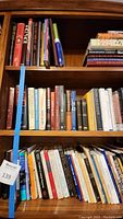 Top three shelves filled with assorted books including visible comic and history titles.