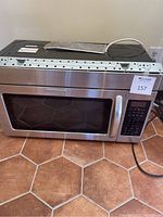 Front view of the stainless steel KitchenAid microwave showing control panel and door with handle.