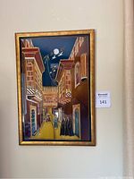 Front view of framed stained glass wall art showing the detailed street scene with buildings, human figures, birds, and moon at night.