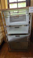 Full front view of wire mesh storage with 5 drawers, showing metal handles and mesh detail.