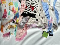 Collection of six Kate Spade cotton scarves arranged side-by-side, showing various colorful prints and patterns.