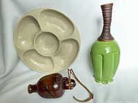Green Large Clique Vase, Hanging Brown Vase and Beige Red Wing USA Snack Dish visibly displayed