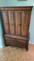 Full front view of the mid-century modern dresser showing four doors and two large bottom drawers