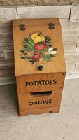 Front view showing entire wooden bin with painted vegetable design on lid and text labels on drawers.
