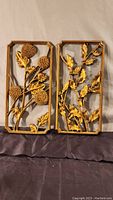 Both Syroco floral wall hangings with detailed floral designs and gold-tone finish side by side against white backdrop.
