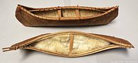 Top view of two handcrafted Haida model canoes showing structure and materials
