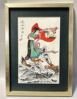 Framed Chinese silk artwork showing a woman in traditional dress and a dragon in flowing waves, signed in Chinese characters.