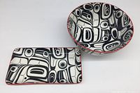 Pair showing round bowl and rectangular plate with abstract black and white pattern and red rims.