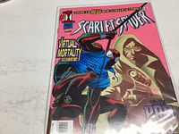 Scarlet Spider comic book #3 cover showing Scarlet Spider character and a hooded figure with vibrant pink background.