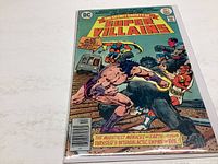 Photo showing the front cover of The Secret Society of Super Villains #4 comic book with vibrant artwork and title clearly visible.