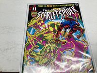 Front cover of The Amazing Scarlet Spider #2 comic book showing colorful action scene and title.
