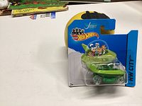 Front angled view of unopened Hot Wheels toy car featuring Jason's vehicle from The Jetsons in original blue blister card packaging.