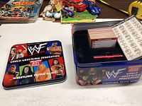 WWF Wrestling Trivia Game tin lid showing additional wrestling personalities and branding.
