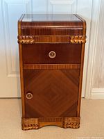 Front view showing drawer, cabinet door and carved rope detailing