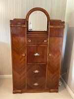 Front view showing arched mirror, two side cabinets, central drawers