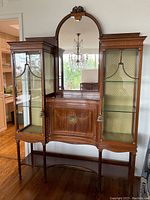 Full front view showing central cabinet with mirror flanked by two glass display cases