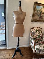 Full view of entire canvas dress form on wooden tripod stand