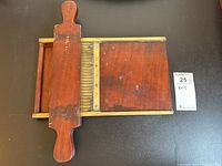 Top-down view of the wooden pill sorter showing the brass grooves and sliding drawer.