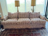 Front view of the entire sofa showing three seat and back cushions, upholstery pattern and overall form