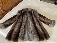 Full jacket laid flat showing fur texture and lining.