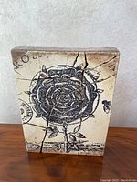 Front view of Sid Dickens ceramic tile showing the detailed black rose design and crack lines.