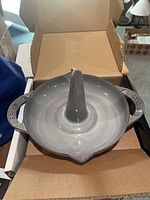 Top view of the grey ceramic vertical chicken roaster in packaging, showing the cone center and handles.