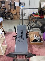 Total Gym Elite circuit trainer showing full equipment with handle and padded bench.