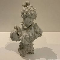 Front view showing detailed curly hair, facial features and ruffled dress.