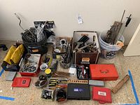 Overview of lot showing multiple containers and boxes with assorted hand tools, drill bits, screwdrivers, wrenches, and toolboxes.