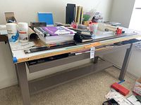 Full view of metal drafting table with supplies