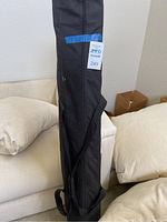 Carrying case with strap and auction label.