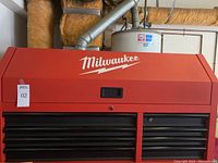 Front view of red Milwaukee tool chest exterior with hinged lid closed
