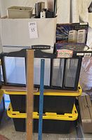 Stack of storage containers, Bankers Box, office electronics, and rolling caddy drawers