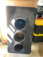 Front view showing all three light lenses vertically aligned in a rectangular metal frame