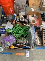 Full view of the lot with miscellaneous hardware, extension cords, tape, and buckets