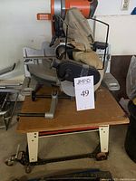 Front view of saw mounted on JET stand with dust collection bag and lot tag