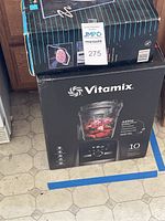 Stacked boxes of Vitamix and Oster waffle maker showing lot contents