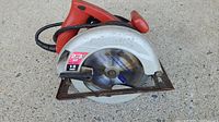 Side view of 13 amp Skilsaw circular saw showing motor rating sticker and blade guard with Skilsaw branding.