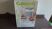 Image showing boxed Cuisinart frozen yogurt, ice cream and sorbet maker with product details and marketing images.
