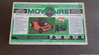 Box showing Mow Aire lawn aerating system branding and usage instructions, indicating it converts a lawn mower into an aerator.