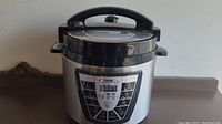 Front view of Power Pressure Cooker XL showing the lid and handles.