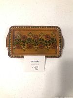 Top-down view of rectangular wooden serving tray showing full floral design and color.