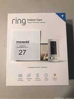 Front of the Ring Indoor Cam box showing product image and key features: 1080p HD Video, Two-Way Talk, Motion Activated, Easy Install, Plug-In Power.