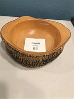 Top view of the oval jacaranda wooden bowl showing its smooth interior and natural bark rim.