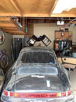 Rear exterior view showing black paint, Porsche reflector tail light and engine lid